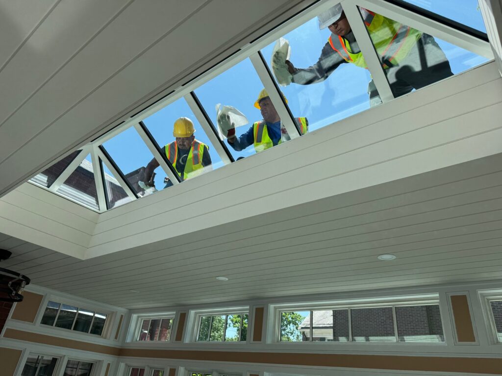 Interior view of a VELUX metal-framed commercial skylight delivering even daylight in a Rhode Island facility